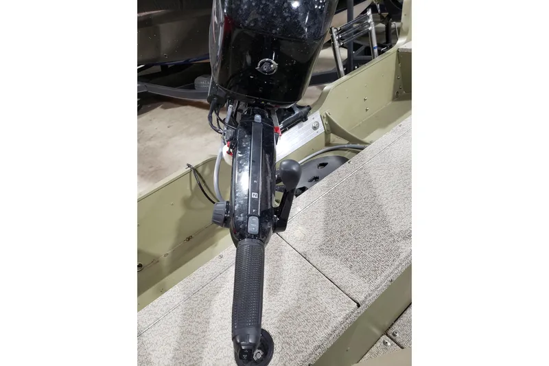 Slide: The Image of 2024 Lund 1675 Alaskan Tiller boat's steering handle and controls, close-up view. - 7