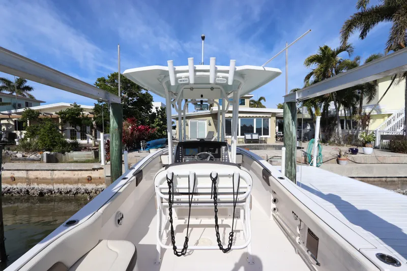 Slide: The Image of 2019 Robalo R242 Center Console boat docked near waterfront homes. - 12