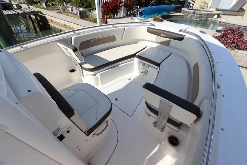 Slide: The Image of 2019 Robalo R242 Center Console boat interior with cushioned seating and storage compartments. - 22