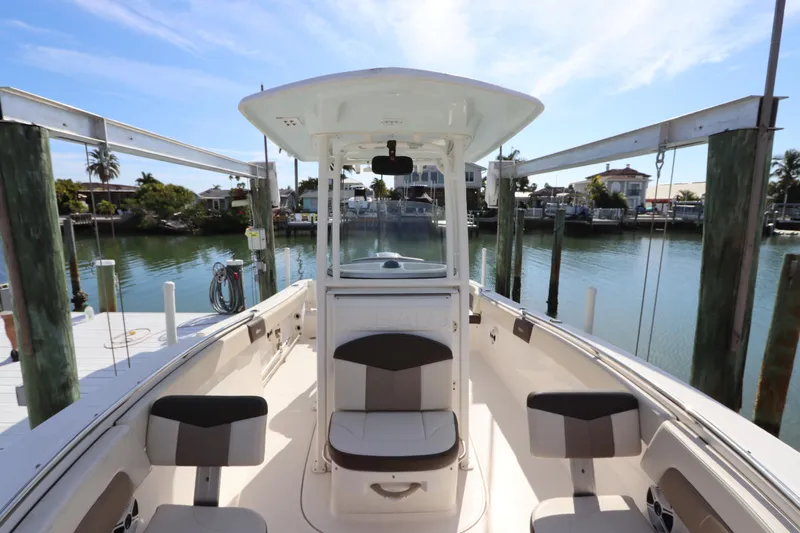 Slide: The Image of 2019 Robalo R242 Center Console boat docked at a scenic waterfront. - 27