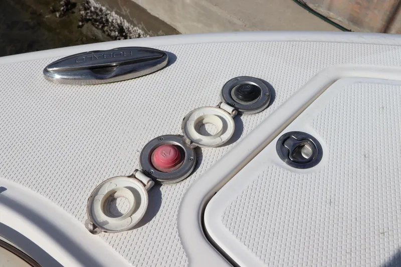 Slide: The Image of 2019 Robalo R242 Center Console boat deck with fittings and hatches. - 26