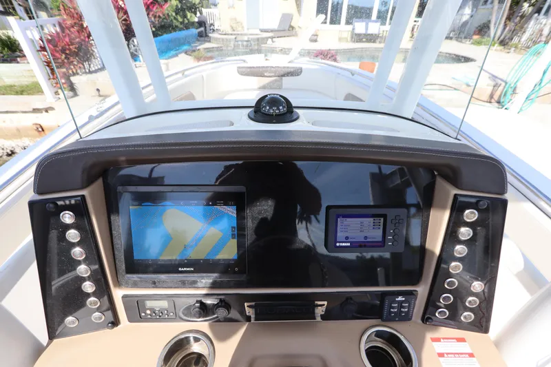 Slide: The Image of 2019 Robalo R242 Center Console dashboard with Garmin and Yamaha displays. - 17