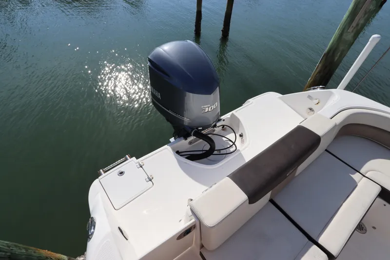 Slide: The Image of 2019 Robalo R242 Center Console boat with Yamaha 300 engine, docked on calm water. - 3