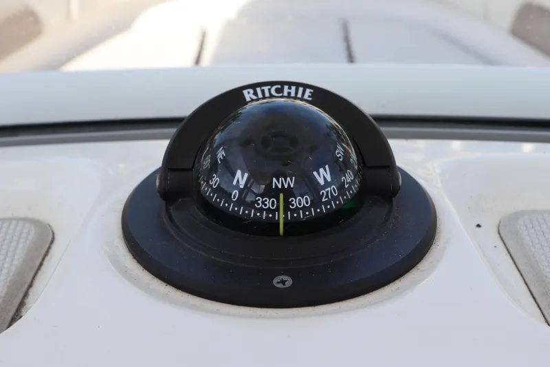Slide: The Image of Compass on 2019 Robalo R242 Center Console boat dashboard. - 19