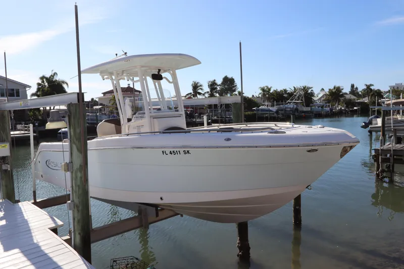 The Image of 2019 Robalo R242 Center Console boat docked in a sunny marina. - 0