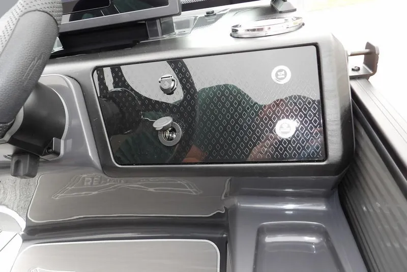 Slide: The Image of 2026 Bennington M L-Bench 22 ML dashboard with sleek black panel and controls. - 23