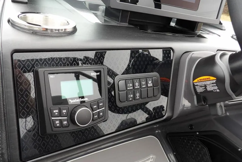 Slide: The Image of Control panel of 2026 Bennington M L-Bench 22 ML boat with audio system and switches. - 24