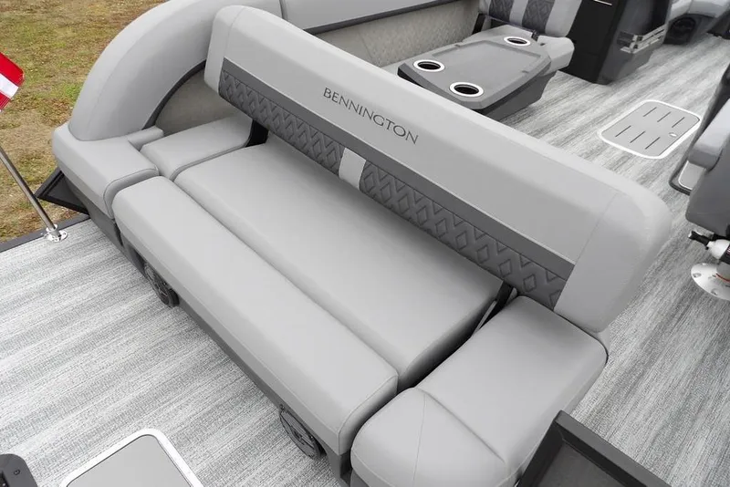 Slide: The Image of 2026 Bennington M L-Bench 22 ML boat interior with gray seating and cup holders. - 33