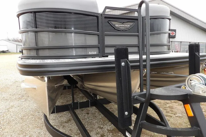Slide: The Image of 2026 Bennington M L-Bench 22 ML pontoon boat on trailer, front view. - 48