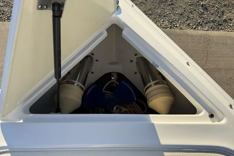 Slide: The Image of Open storage compartment on 2017 Cobalt R3 boat, revealing anchor and accessories. - 11