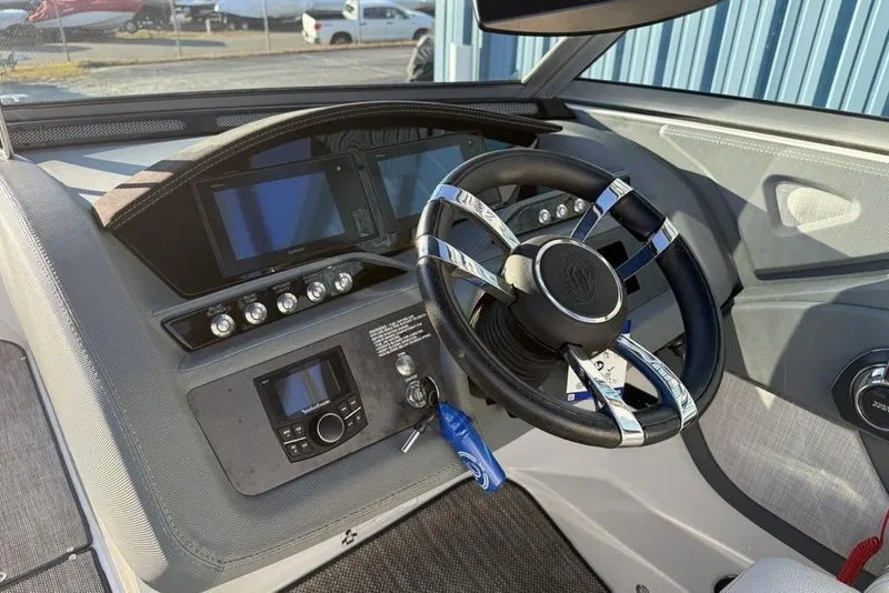 Slide: The Image of 2017 Cobalt R3 boat dashboard with modern steering wheel and control panel. - 14