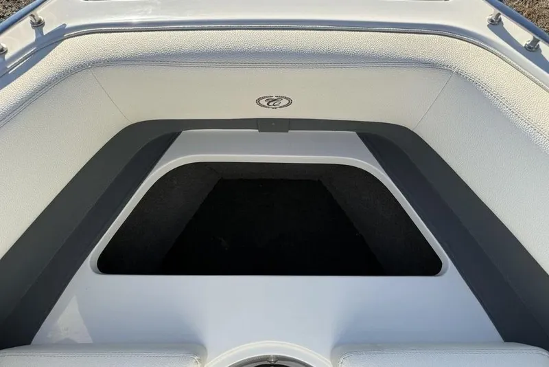 Slide: The Image of 2017 Cobalt R3 boat interior storage compartment with white and gray upholstery. - 2