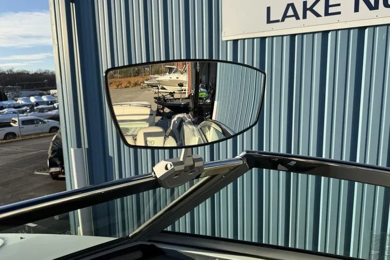 Slide: The Image of Rearview mirror on a 2017 Cobalt R3 boat, reflecting a marina scene. - 22