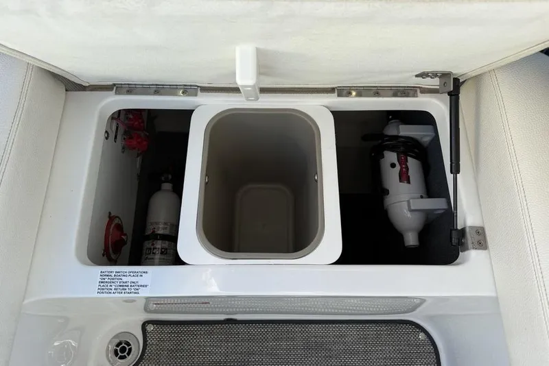 Slide: The Image of 2017 Cobalt R3 boat storage compartment with fire extinguisher and battery switch. - 35