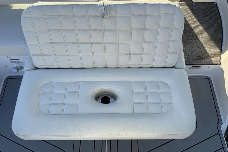 Slide: The Image of White cushioned seat on 2017 Cobalt R3 boat, featuring a central cup holder. - 43