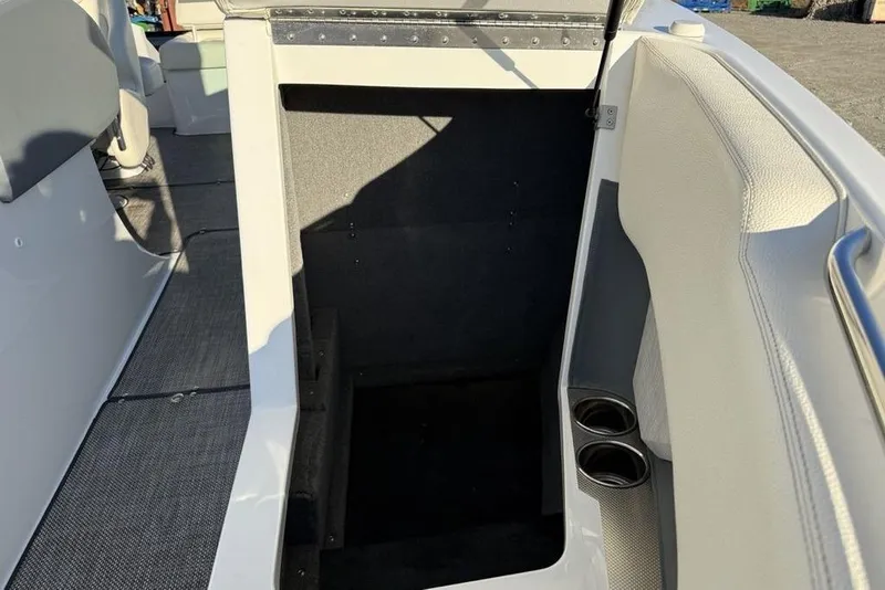 Slide: The Image of 2017 Cobalt R3 boat interior with storage compartment and cup holders. - 5