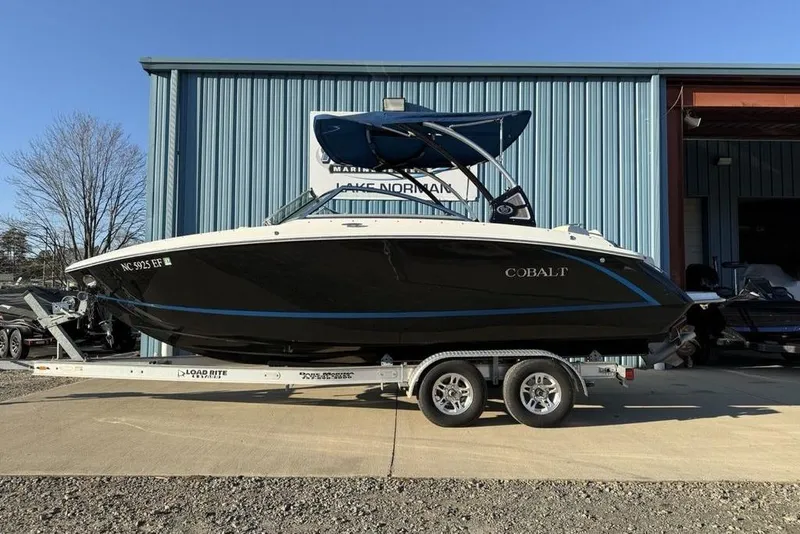 Slide: The Image of 2017 Cobalt R3 boat on trailer outside a blue building. - 50