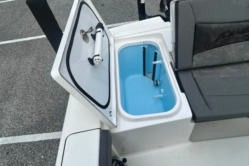 Slide: The Image of 2022 Crevalle 26 HBW boat with open storage compartment and seating area. - 10