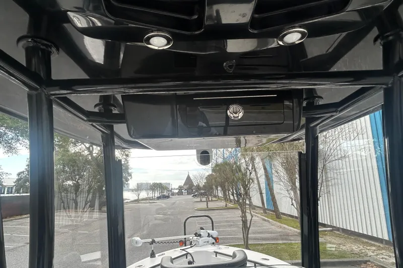 Slide: The Image of 2022 Crevalle 26 HBW boat interior with black roof and outdoor view. - 15