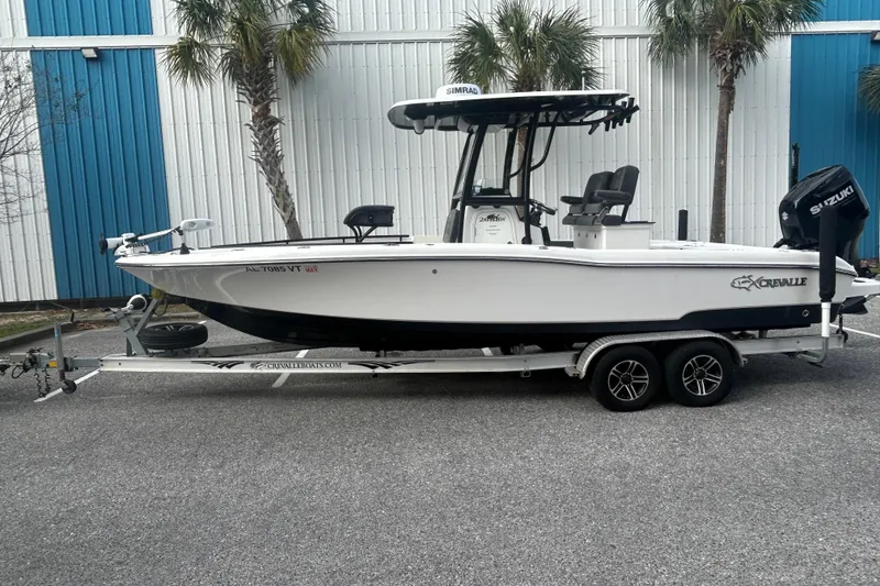 Slide: The Image of 2022 Crevalle 26 HBW boat on trailer, parked near palm trees. - 3