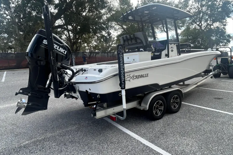 Slide: The Image of 2022 Crevalle 26 HBW boat on trailer with Suzuki outboard motor in parking lot. - 6