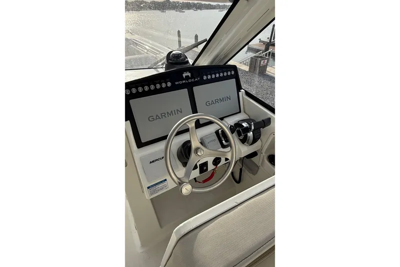 Slide: The Image of Helm of 2023 World Cat 280 DC-X with Garmin displays and steering wheel. - 20