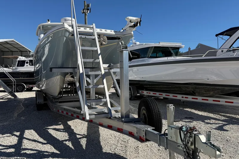 Slide: The Image of 2023 World Cat 280 DC-X boat on trailer in marina setting. - 21