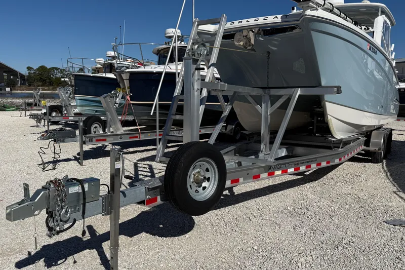 Slide: The Image of 2023 World Cat 280 DC-X boat on trailer in a gravel lot. - 22