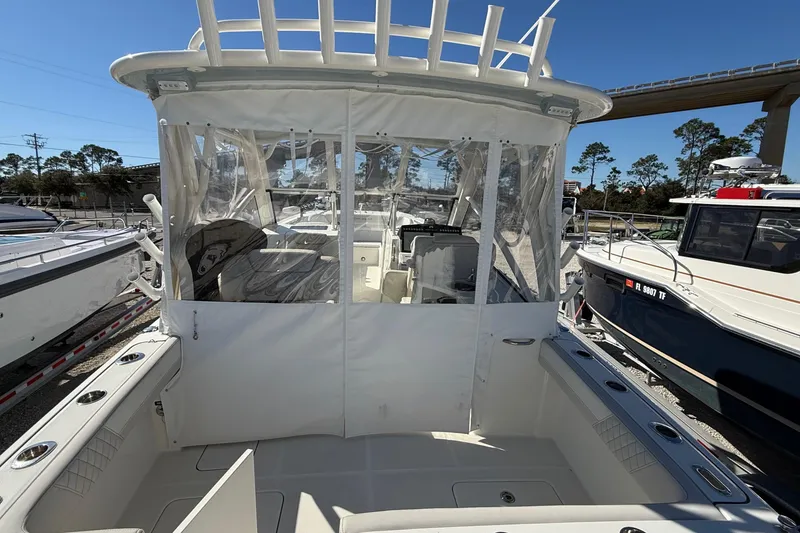 Slide: The Image of 2023 World Cat 280 DC-X boat with enclosed cockpit, docked outdoors. - 37