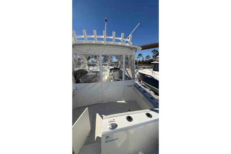 Slide: The Image of 2023 World Cat 280 DC-X boat interior with clear canopy and seating area. - 38