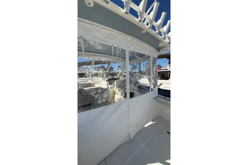 Slide: The Image of 2023 World Cat 280 DC-X boat with enclosed seating area and clear windows. - 40