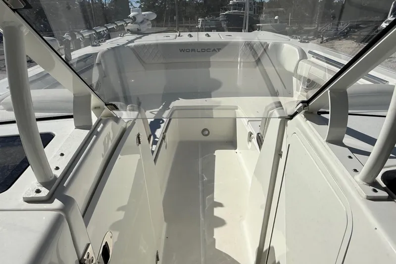 Slide: The Image of 2023 World Cat 280 DC-X boat interior with open windshield and seating area. - 44