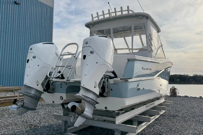 Slide: The Image of 2023 World Cat 280 DC-X boat with dual outboard motors on a dock. - 5