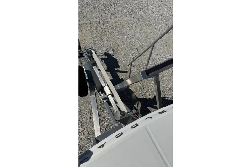 Slide: The Image of 2023 World Cat 280 DC-X boat trailer hitch on gravel surface. - 52