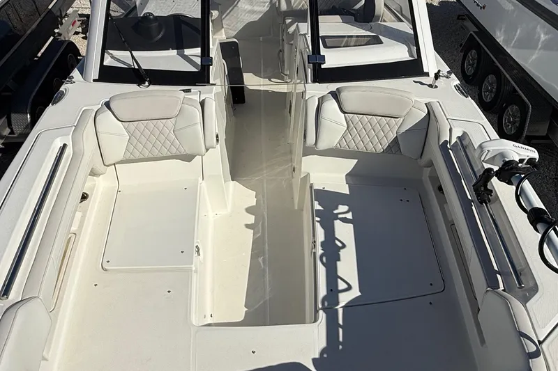 Slide: The Image of 2023 World Cat 280 DC-X boat interior with white seating and modern design. - 53