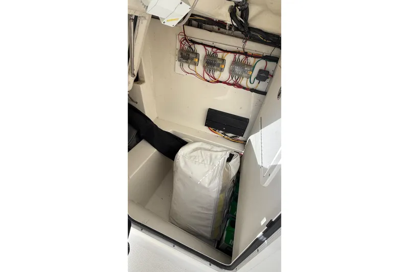 Slide: The Image of 2023 World Cat 280 DC-X storage compartment with wiring and equipment. - 56