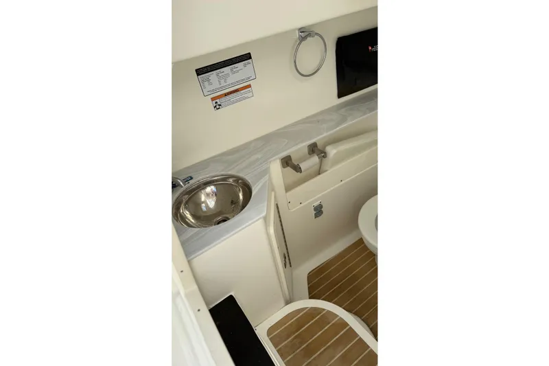 Slide: The Image of 2023 World Cat 280 DC-X boat interior with sink and toilet. - 58