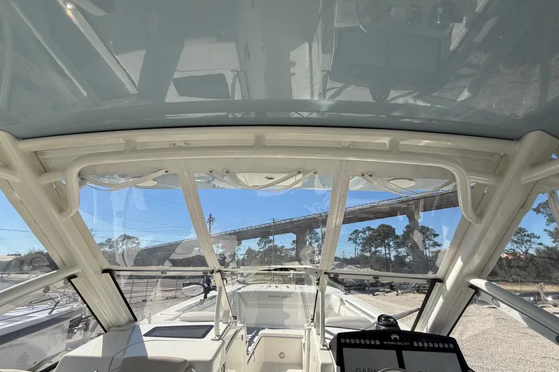Slide: The Image of 2023 World Cat 280 DC-X boat interior with clear canopy and dashboard view. - 62