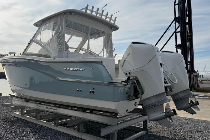 Slide: The Image of 2023 World Cat 280 DC-X boat with dual Mercury outboard engines on a dock. - 8