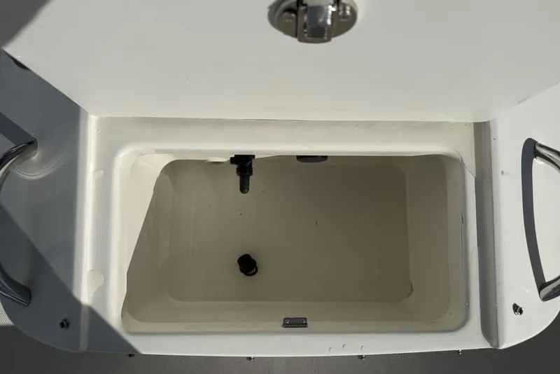 Slide: The Image of Open storage compartment on 2019 Bayliner Element E18 boat. - 11