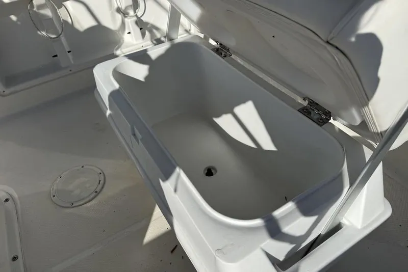 Slide: The Image of 2019 Bayliner Element E18 boat storage compartment with open lid, showcasing interior space. - 15