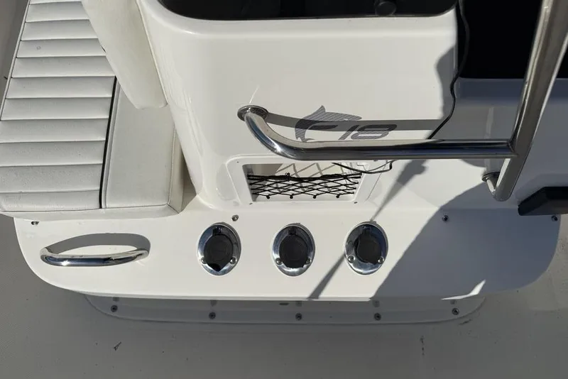 Slide: The Image of 2019 Bayliner Element E18 boat deck with seating and chrome details. - 17