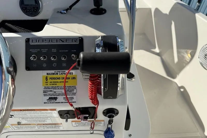 Slide: The Image of Control panel of a 2019 Bayliner Element E18 boat with capacity details. - 18