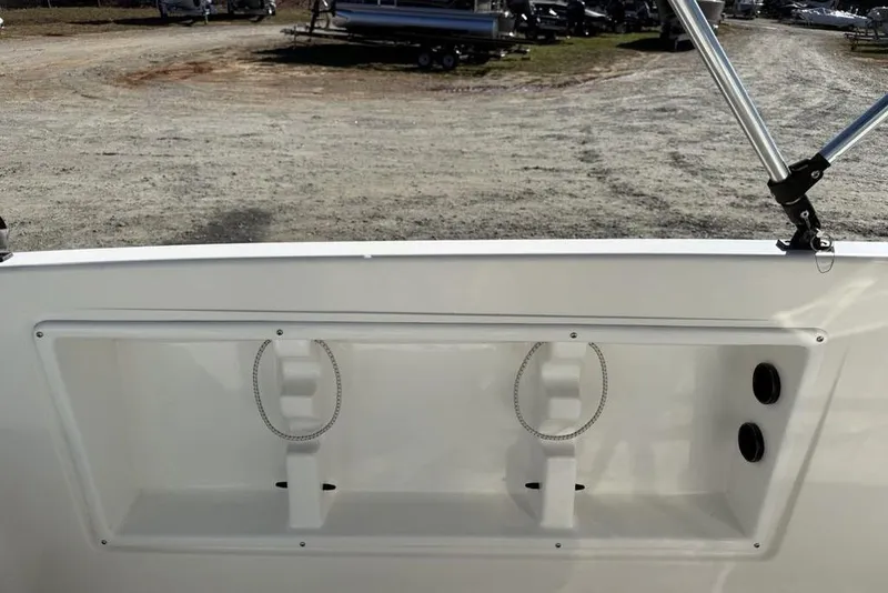 Slide: The Image of 2019 Bayliner Element E18 boat interior with storage compartment and rod holders. - 21