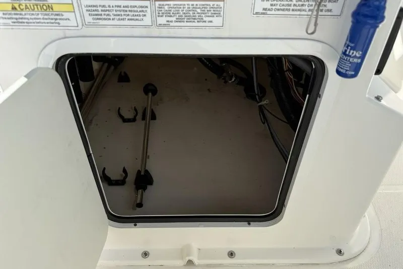 Slide: The Image of 2019 Bayliner Element E18 storage compartment with open hatch and visible interior components. - 23