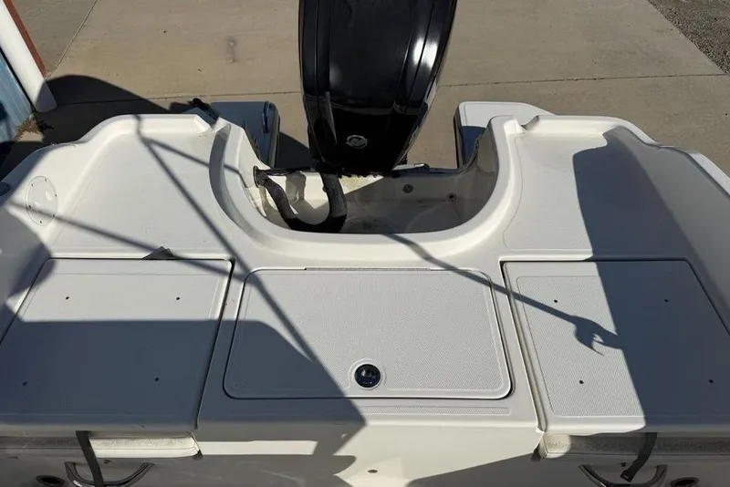 Slide: The Image of 2019 Bayliner Element E18 boat stern with outboard motor and storage compartments. - 25