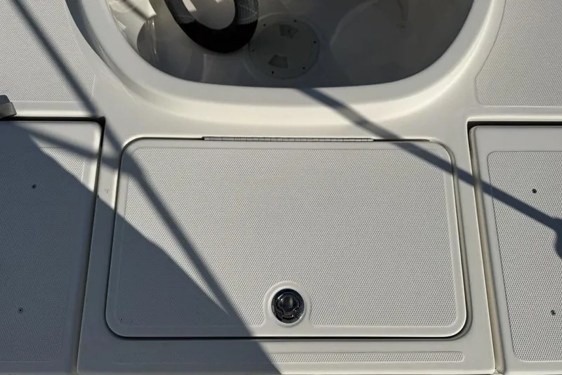 Slide: The Image of 2019 Bayliner Element E18 boat deck with storage compartment and steering wheel. - 29