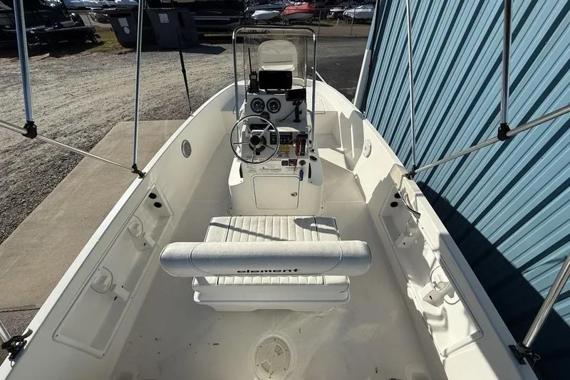 Slide: The Image of 2019 Bayliner Element E18 boat interior with steering console and seating. - 32