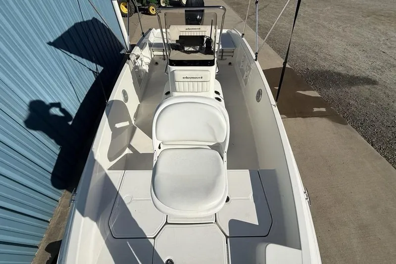 Slide: The Image of 2019 Bayliner Element E18 boat interior with white seating and steering console. - 33