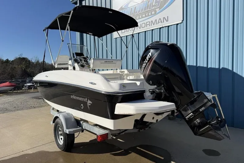 Slide: The Image of 2019 Bayliner Element E18 boat with Mercury engine on trailer, parked outdoors. - 4